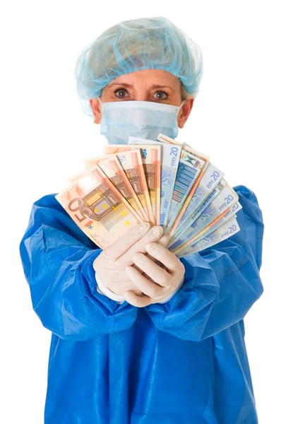 Female surgeon holding banknotes — Stock Photo, Image