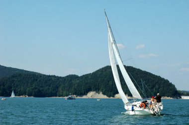 Sailing on Solina Lake, Poland clipart