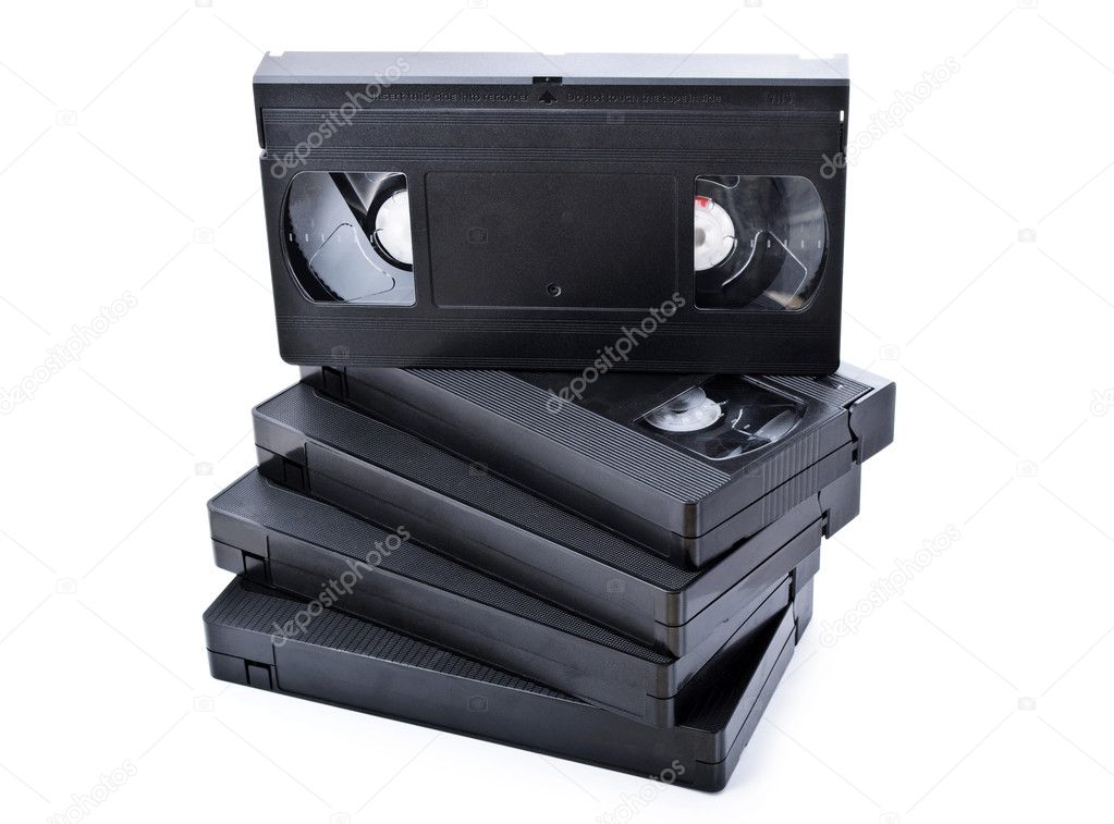 Stack of black old video cassettes isolated on white background