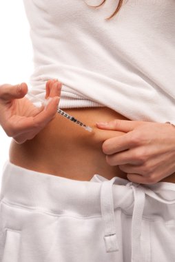 First type Diabetes patient giving herself abdomen insulin injection shot by single use syringe with dose of lantus isolated on a white background clipart