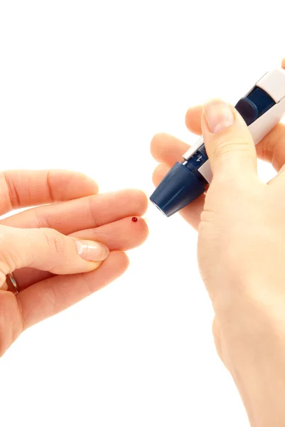 Lancet in hand prick finger for blood glucose level — Stock Photo, Image