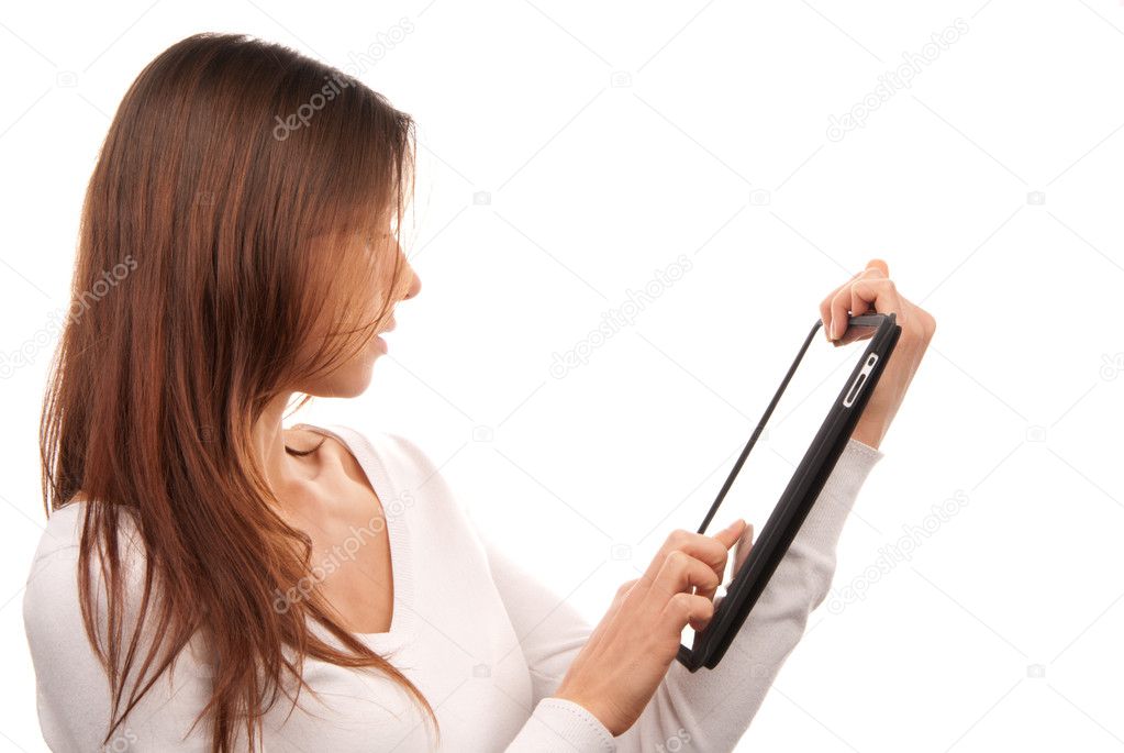 Pretty brunette woman typing on her new electronic tablet touch pad computer pc one finger touches the digital screen isolated on a white background