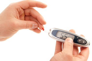 Diabetic patient measuring glucose level blood test using ultra mini glucometer and small drop of blood from finger and test strips isolated on a white backgrou clipart