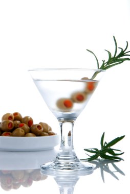 Classic Martini with vodka, three little green olives filled by red papper inside and rosemary composition isolated on a white background clipart