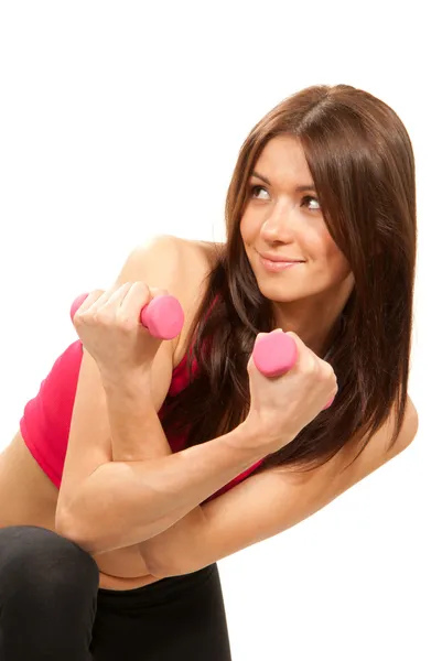 ピンクのミニと完璧な運動ボディと腹筋トレーニングとかなりブルネット フィットネス女性講師ダンベル 白い背景で隔離の重み — ストック写真