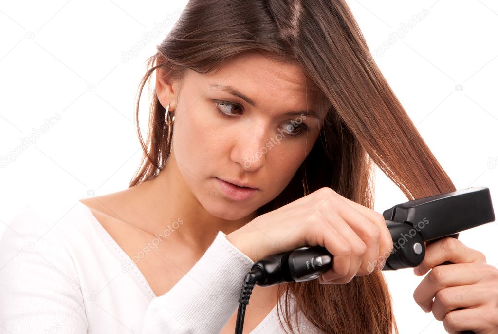 Woman using hair straighteners black flat iron Stock Photo by ©dml5050  4936599