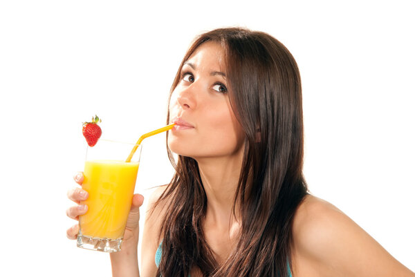 Beautiful Healthy lifestyle brunette woman drinking orange juice cocktail with strawberry with drinking straw in highball glass and looking up isolated on a whi
