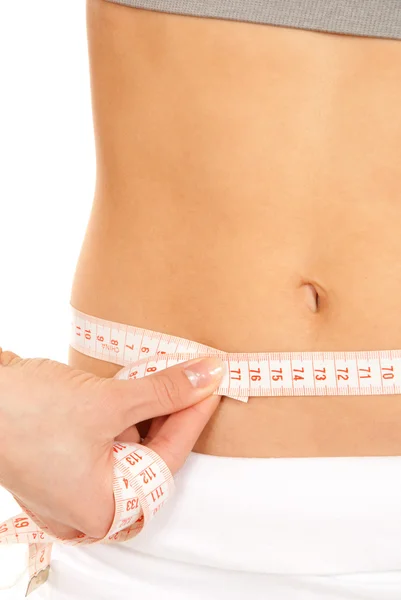 Athletic fit slim female measuring her waist — Stock Photo, Image