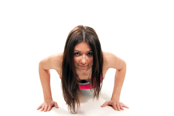 Sportswoman doing push-up or press-up exercise Stock Picture