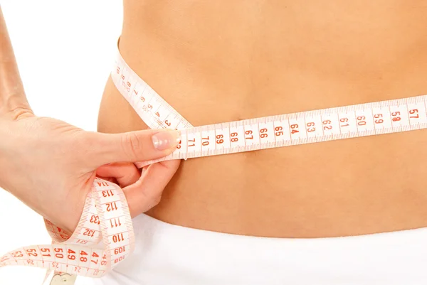 Athletic fit slim female measuring around her waist — Stock Photo, Image
