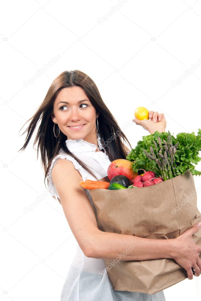 Woman holding a shopping bag full of groceries