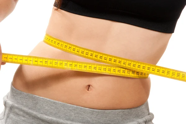 Athletic fit slim female measuring waist — Stock Photo, Image