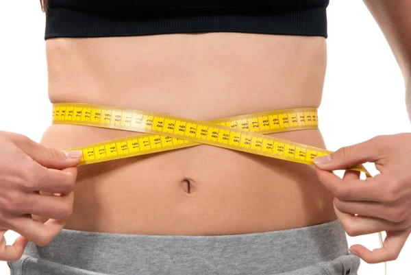 Athletic fit slim female measuring waist — Stock Photo, Image