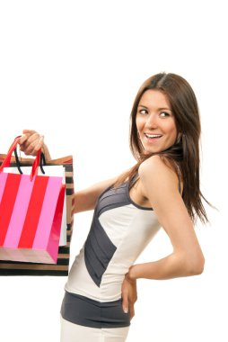 Woman standing, holding credit card and shopping bags in hand clipart