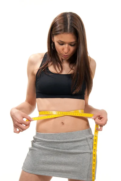 Mujer joven midiendo su cintura — Foto de Stock