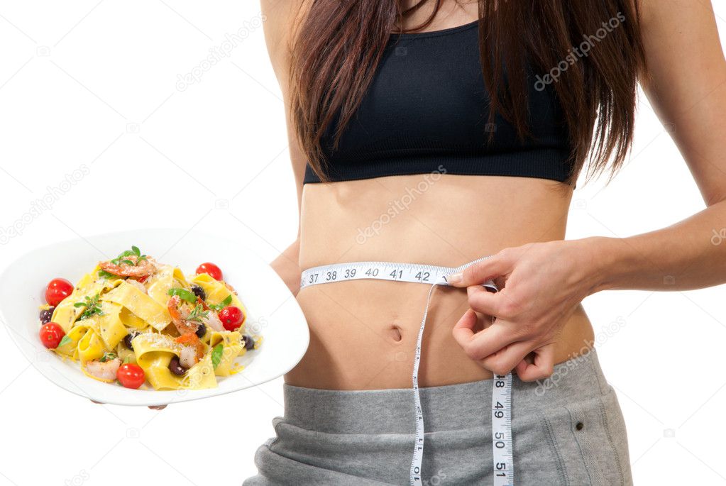 Woman measuring waist and holding diet food