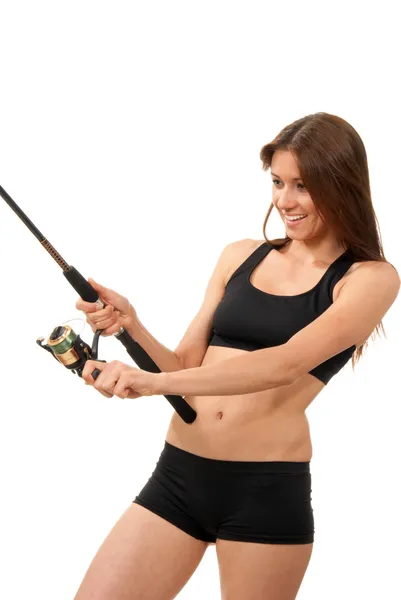 Sport woman holding a fishing rod with reel — Stock Photo, Image
