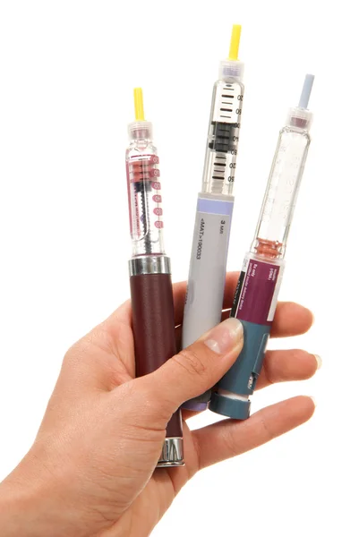 Diabetes insulin dependent Hand with syringes pen injector — Stock Photo, Image