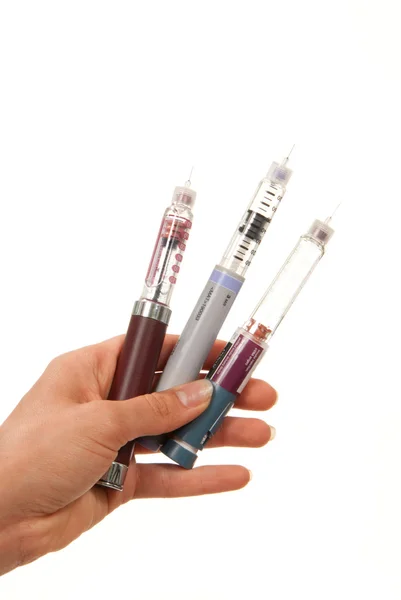 Diabetes insulin Hand with syringes pen injector — Stock Photo, Image