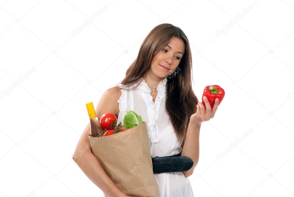 Young woman hold shopping paper bag full of vegetarian groceries