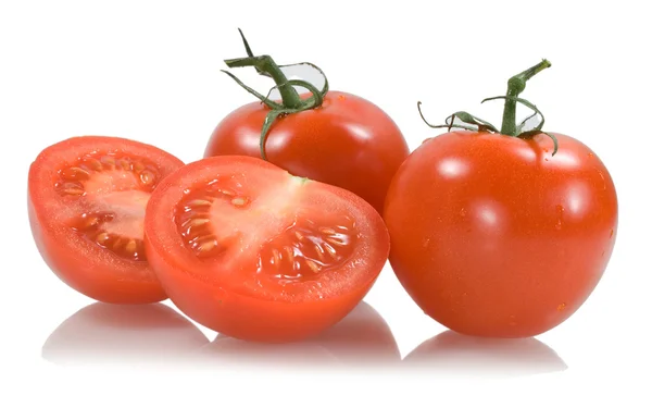 Pomodori rossi con due segmenti di pomodoro Fotografia Stock