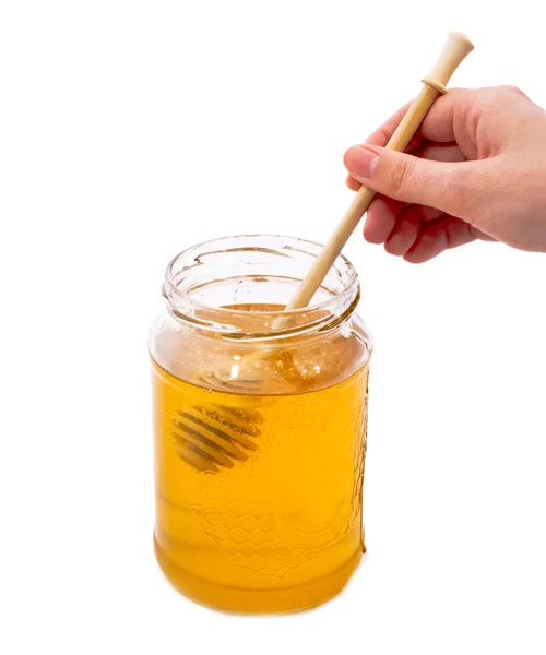Bottle of honey and female hands. — Stock Photo, Image