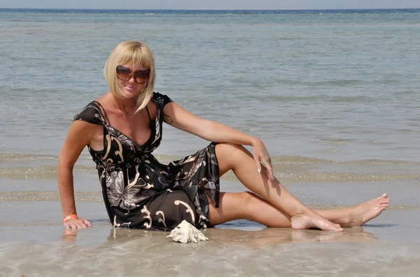 这个女孩有休息的沙滩上 免版税图库照片