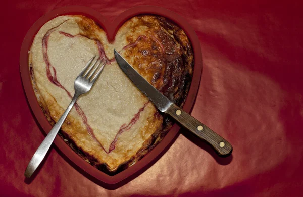 Herzförmige Leicht Verbrannte Torte Für Esser Kopierraum Auf Rotem Hintergrund Stockfoto