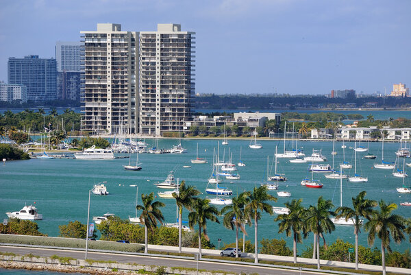 Skyline of the city of Miami with sailboats and a roadway