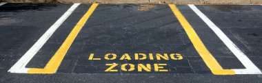 Parking spot designated for loading and unloading only. clipart