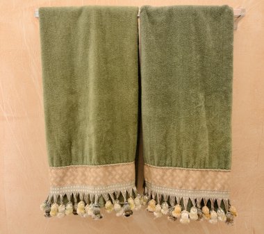 Nice towels with tassels on a towel rack. clipart