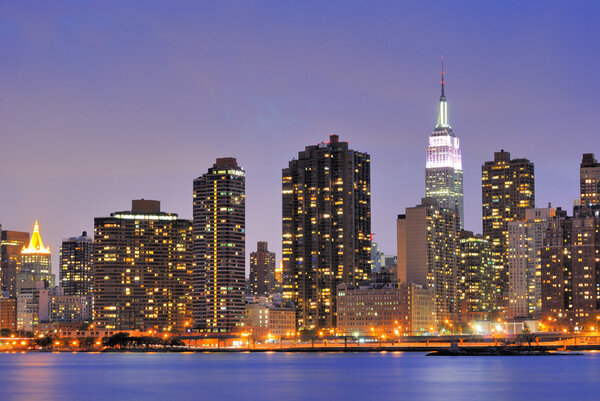 Cityscape of Midtown Manhattan across the Hudson River at night.