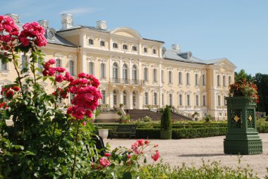 Beautiful roses and Baroque - Rococo style palace in background clipart