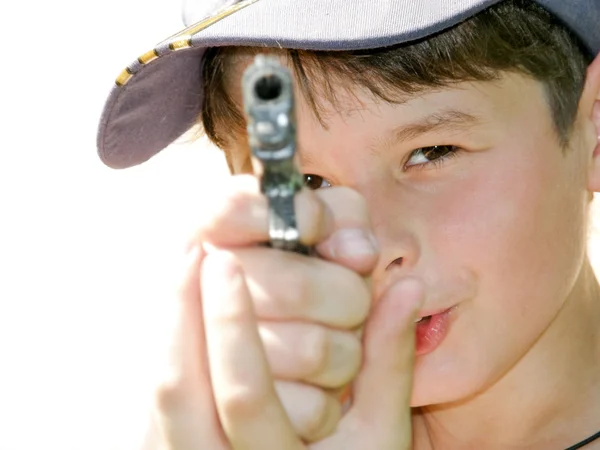 A boy shoots a toy pistol — Stock Photo, Image