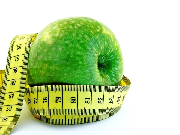 Manzana verde y cinta métrica —  Fotos de Stock