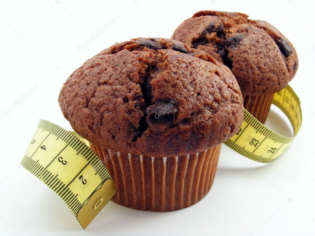 2 chocolate muffins with a measuring tape