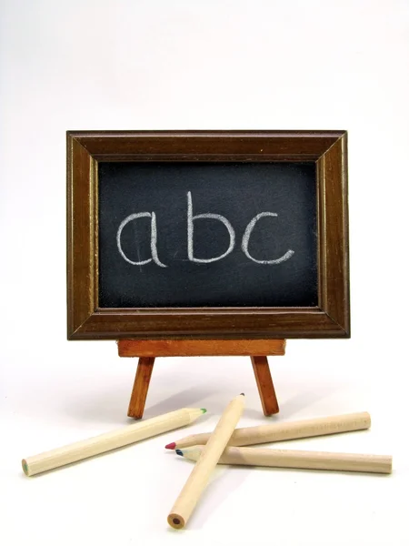 Blackboard with ABC & pencils — Stock Photo, Image