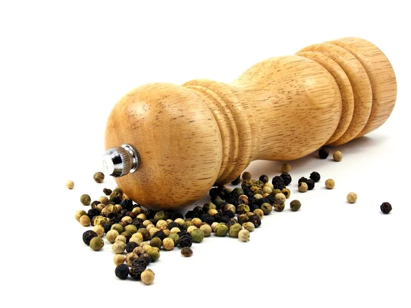 A wooden peppermill with peppercorns — Stock Photo, Image
