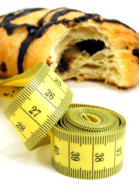 Chocolate pastry cakes & measuring tape — Stock Photo, Image