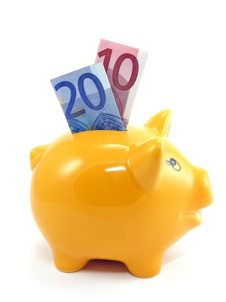 Um banco porquinho com moeda em euros — Fotografia de Stock