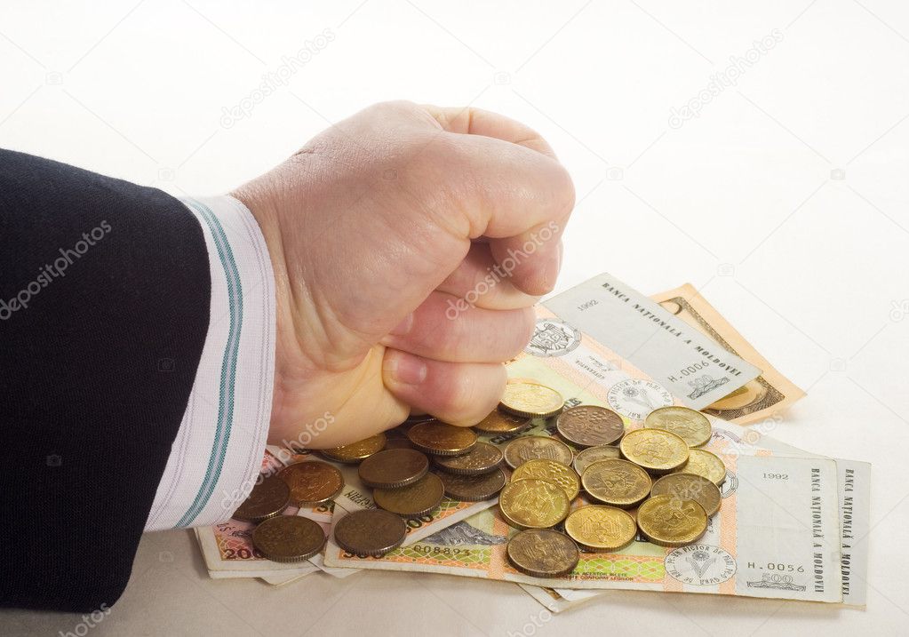 Hand in a fist coins banknotes