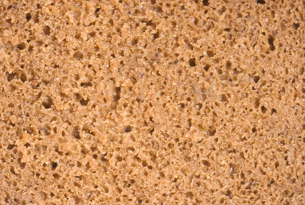 Porous texture of brown bread, cut coarsely — Stock Photo, Image