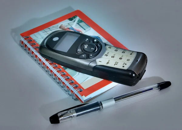 Caderno de telefone caneta — Fotografia de Stock