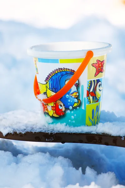 Toy bucket on the snow — Stock Photo, Image