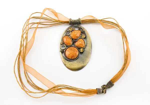 stock image Bronze decoration on an orange ribbon with stones