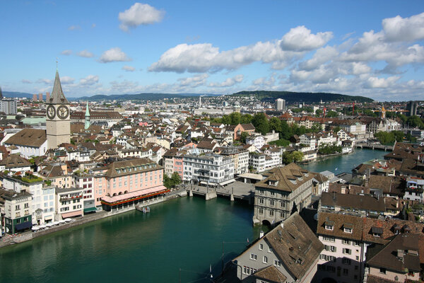 Zurich cityscape. St. Peter's Church tower with world's largest church clock face. Swiss city. Aerial view.