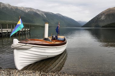 New Zealand. Nelson Lakes National Park - small steamboat ashore Lake Rotoiti. clipart