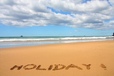 Hot Water Beach in Coromandel peninsula. New Zealand - North Island. Holiday - stick written text. clipart