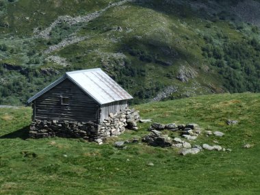 Small wooden shed, typical for Norwegian mountains. Shelter for sheep. clipart