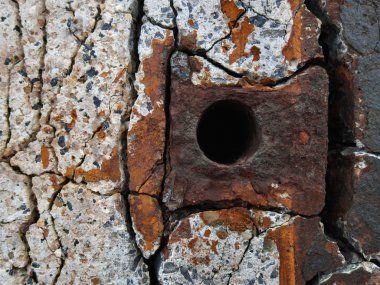 Rusty metal element in concrete wall clipart
